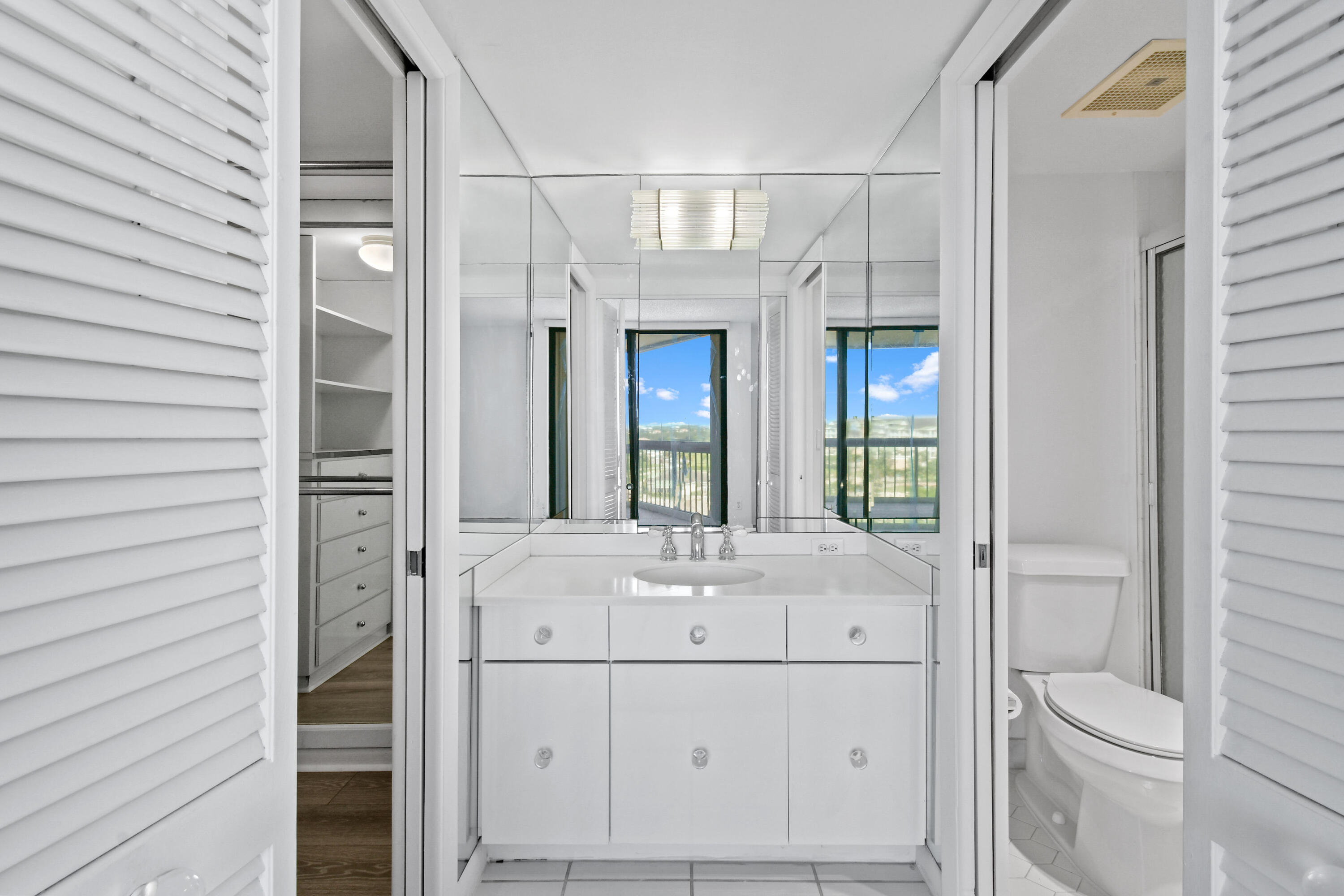 2425 Presidential Way, Unit 801 West Palm Beach, FL 33401 - Photo 13 of 41 a bathroom with a sink a toilet and shower
