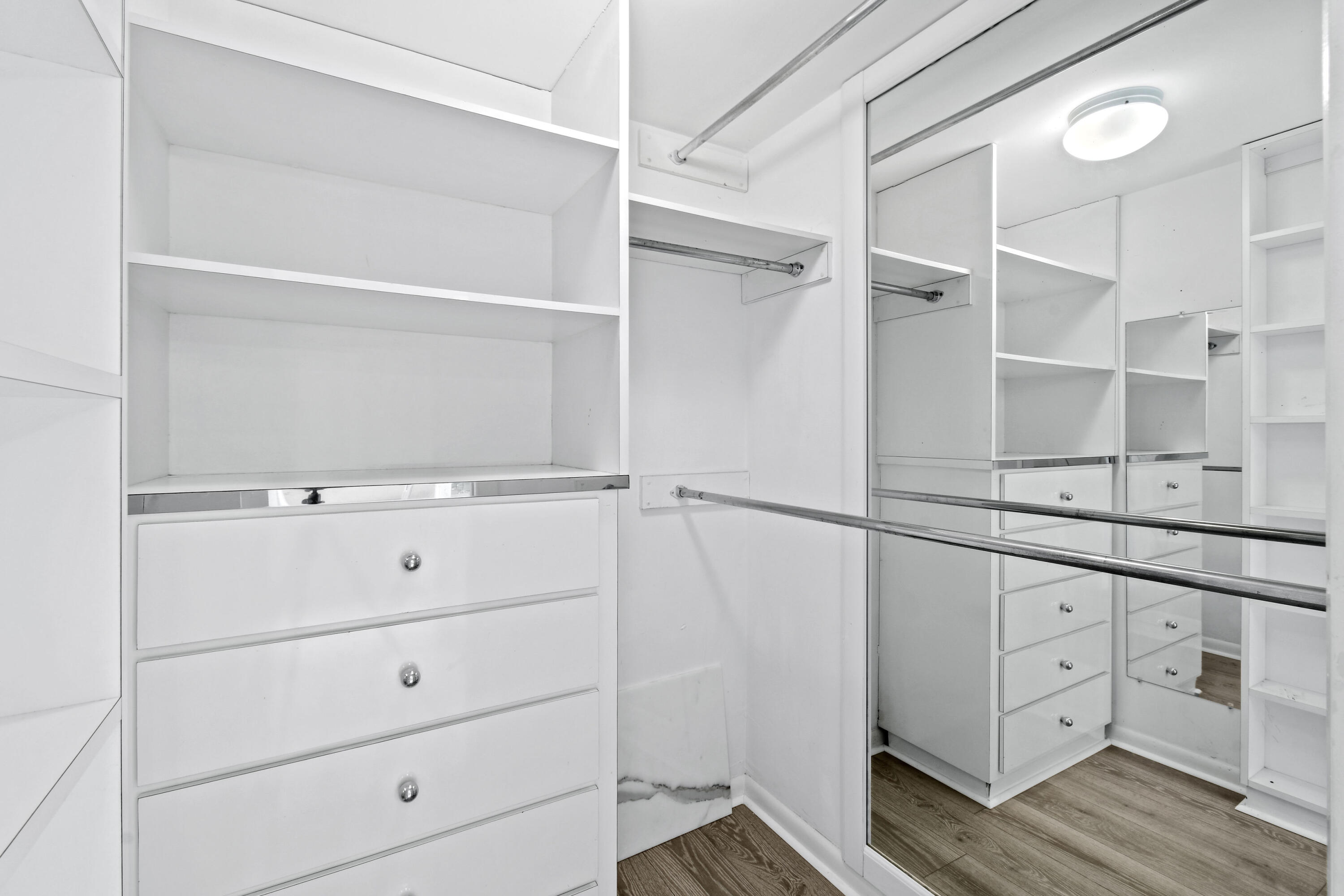 2425 Presidential Way, Unit 801 West Palm Beach, FL 33401 - Photo 15 of 41 a view of white cabinets and wooden floor