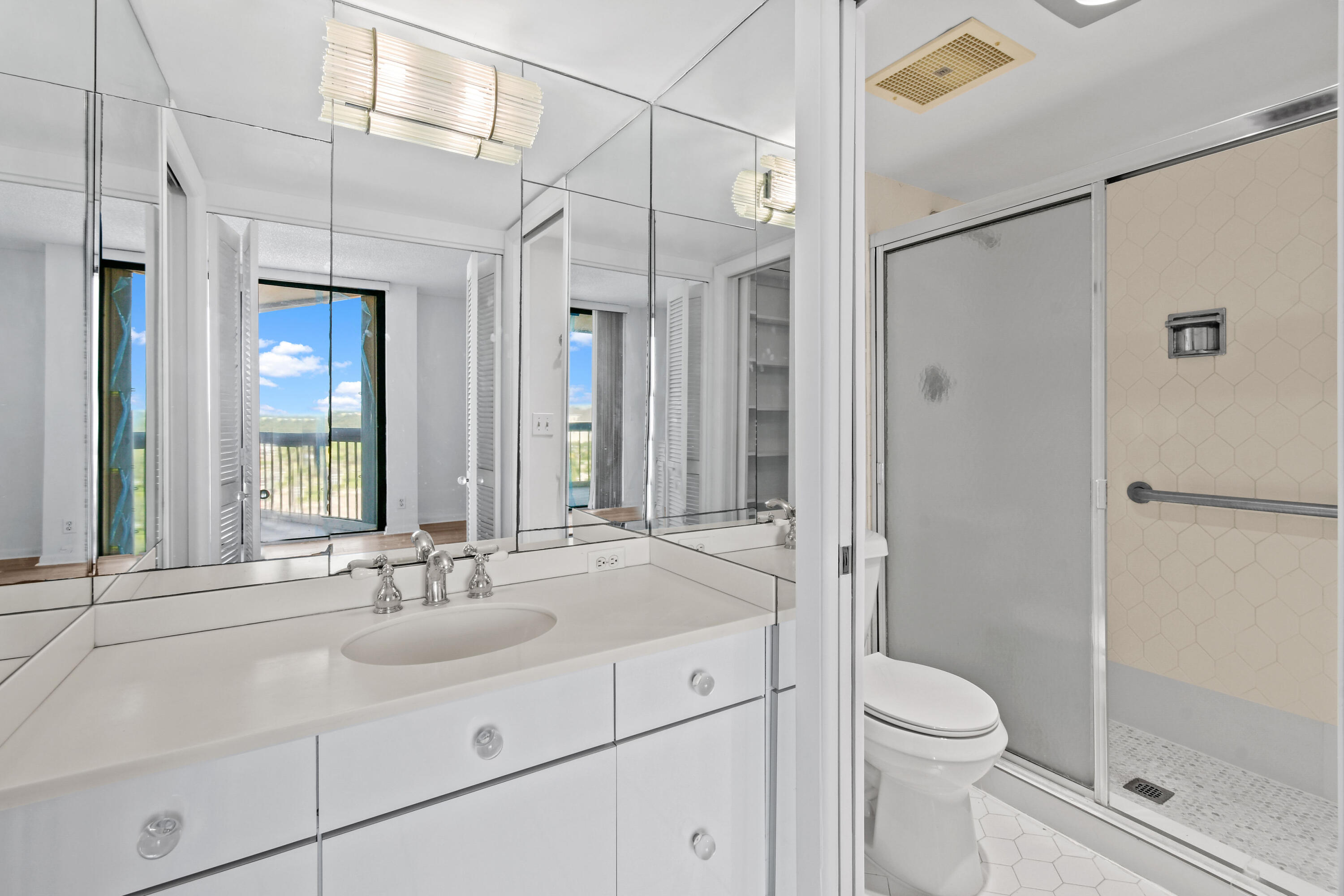 2425 Presidential Way, Unit 801 West Palm Beach, FL 33401 - Photo 16 of 41 a bathroom with a sink a toilet and shower