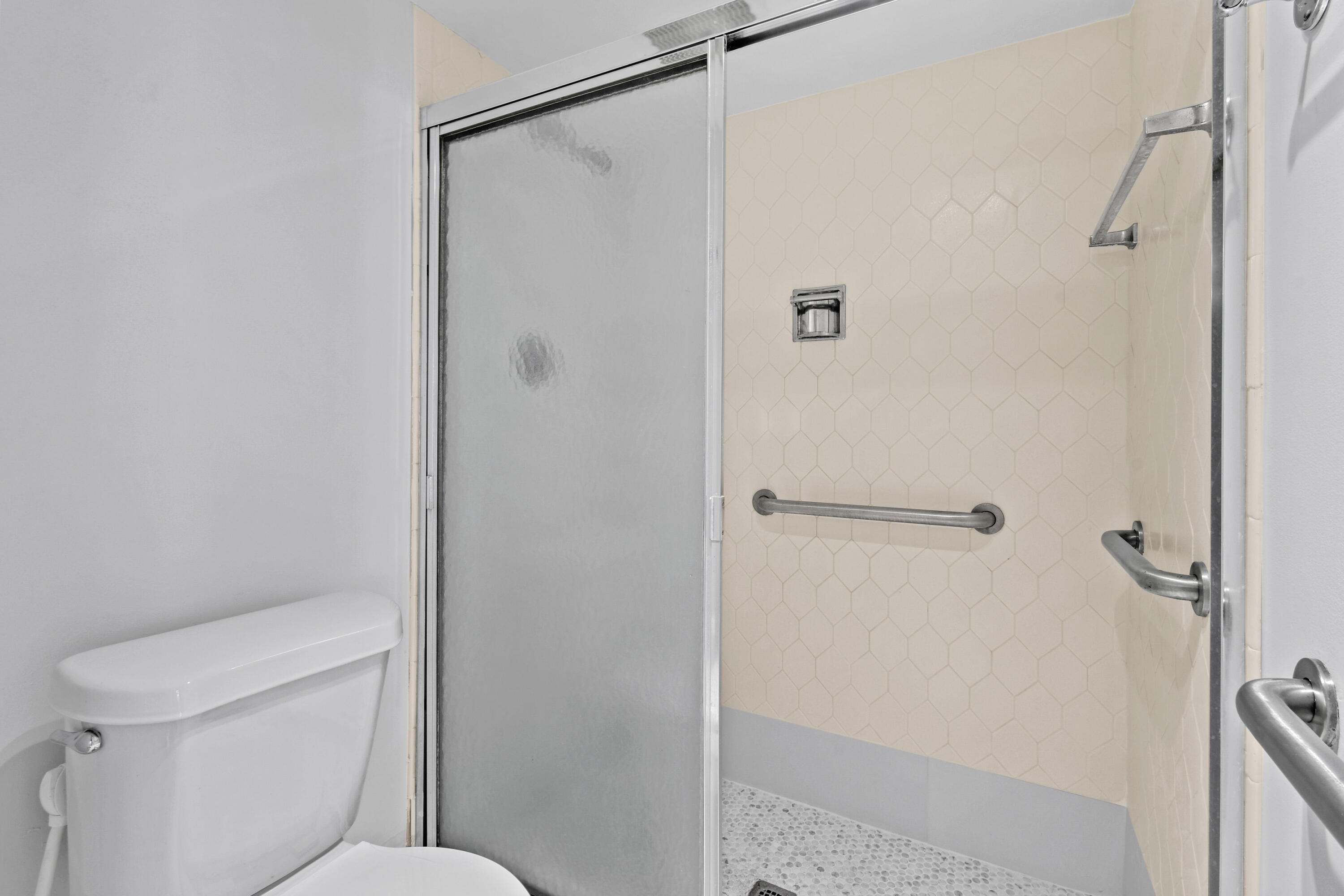 2425 Presidential Way, Unit 801 West Palm Beach, FL 33401 - Photo 17 of 41 a bathroom with a toilet and a shower