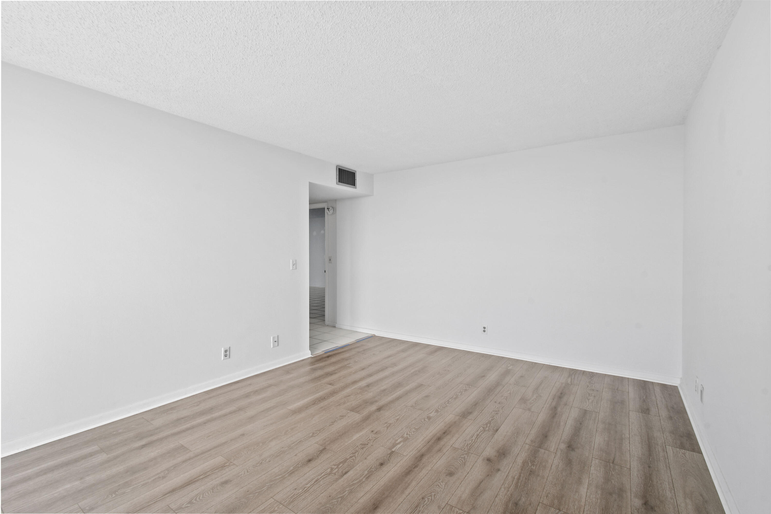 2425 Presidential Way, Unit 801 West Palm Beach, FL 33401 - Photo 24 of 41 an empty room with wooden floor