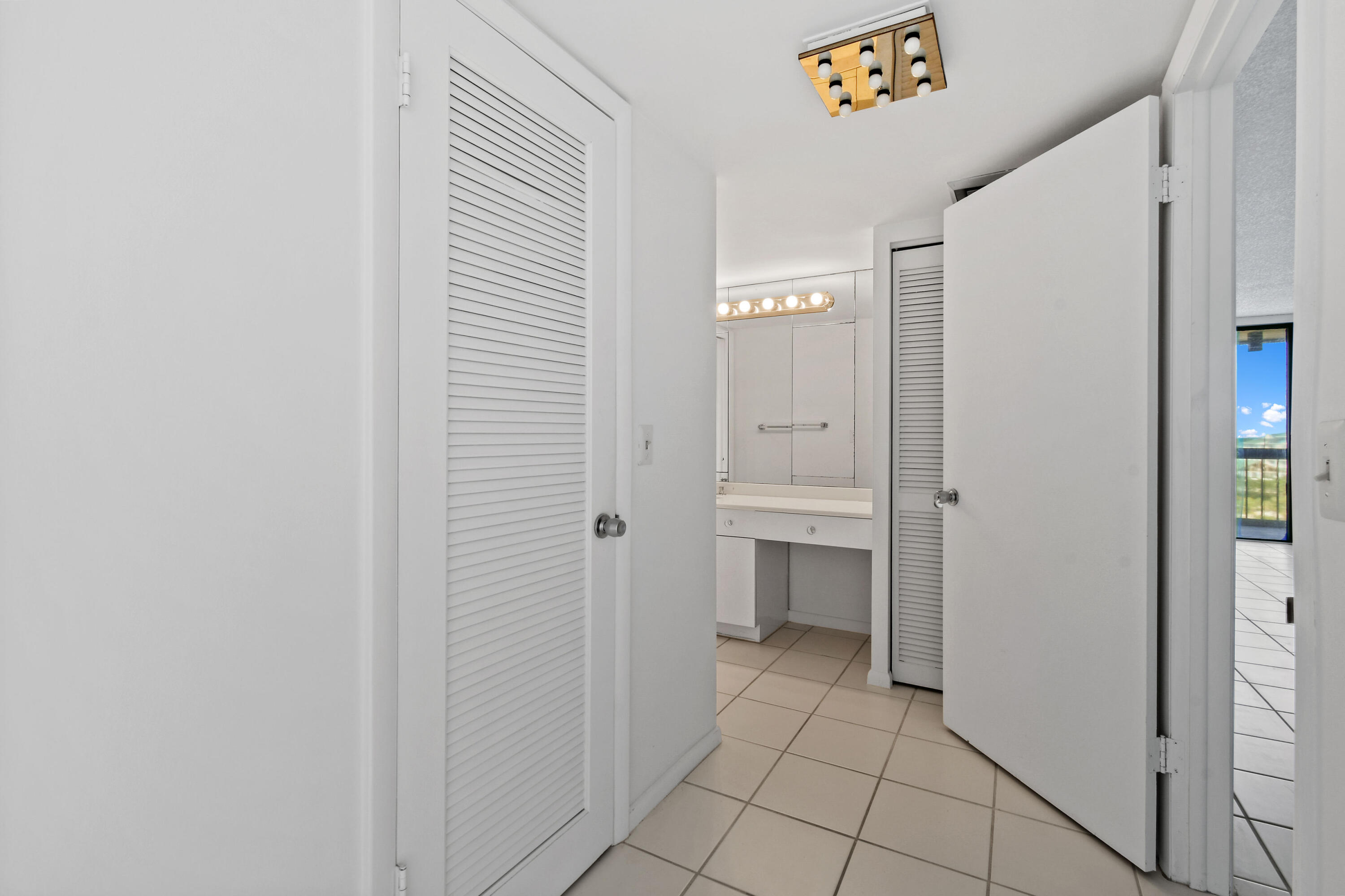 2425 Presidential Way, Unit 801 West Palm Beach, FL 33401 - Photo 26 of 41 a bathroom with a sink and a mirror
