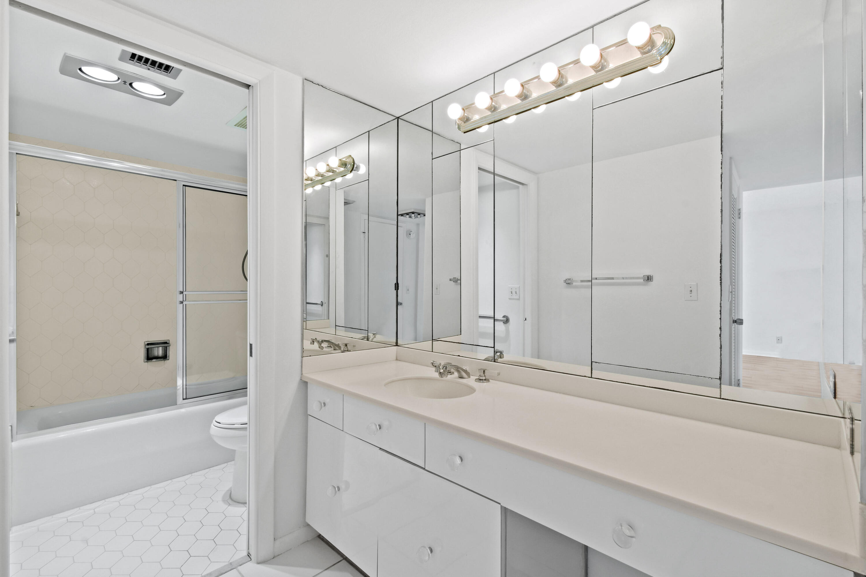 2425 Presidential Way, Unit 801 West Palm Beach, FL 33401 - Photo 28 of 41 a bathroom with a sink a toilet and shower