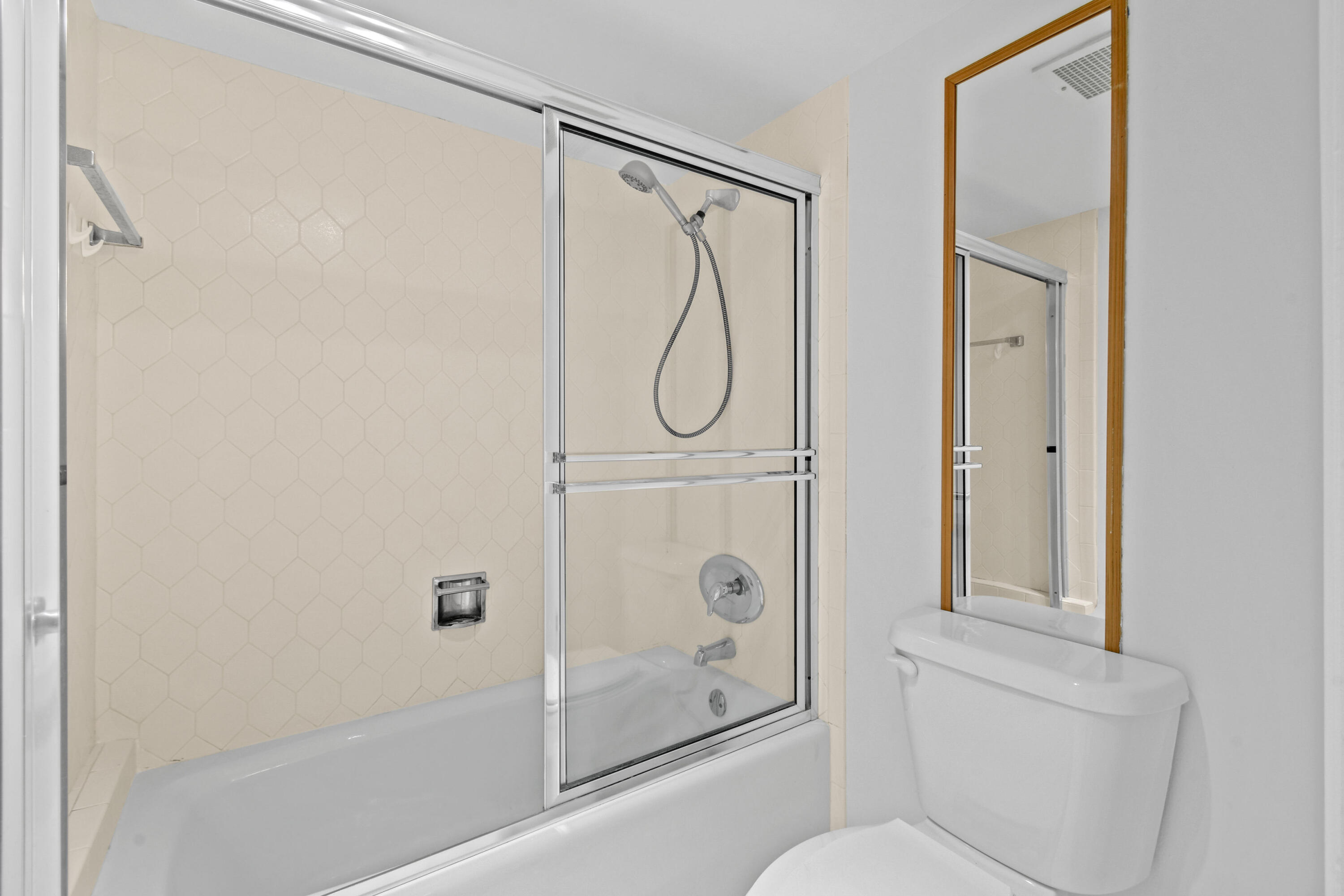 2425 Presidential Way, Unit 801 West Palm Beach, FL 33401 - Photo 29 of 41 a bathroom with a shower a toilet and a glass door