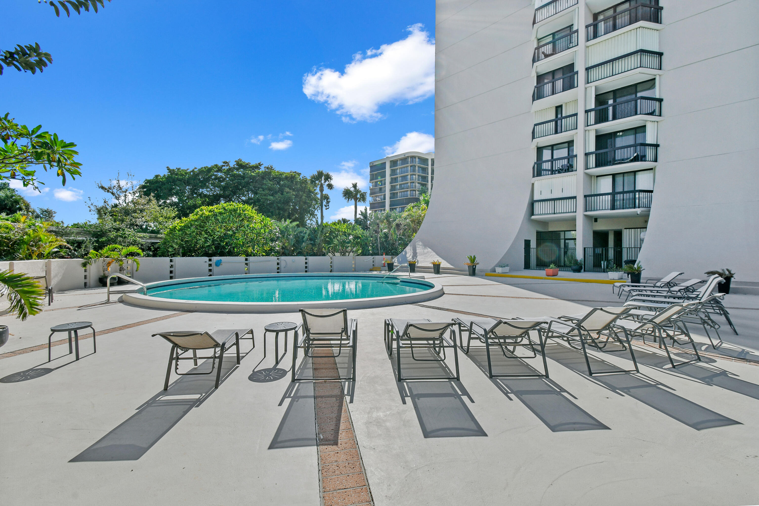 2425 Presidential Way, Unit 801 West Palm Beach, FL 33401 - Photo 36 of 41 a swimming pool with outdoor seating and yard