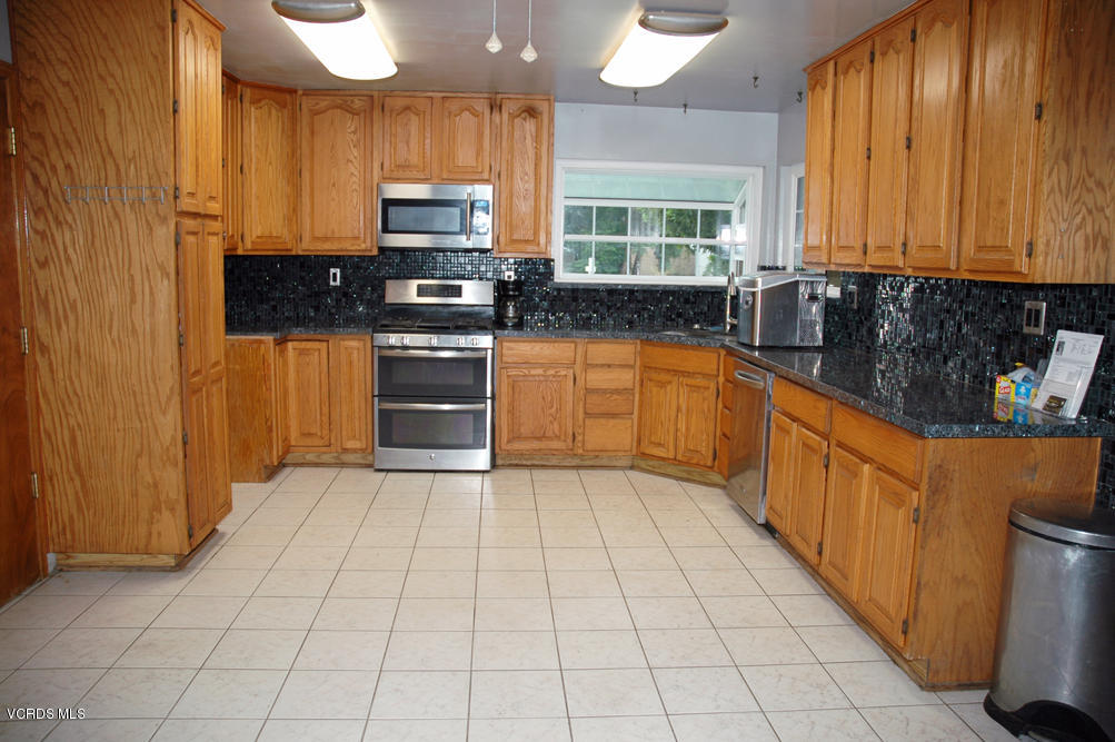 2218 Ralston Street Simi Valley, CA 93063 - Photo 2 of 23 a kitchen with stainless steel appliances granite countertop a stove a sink and a microwave