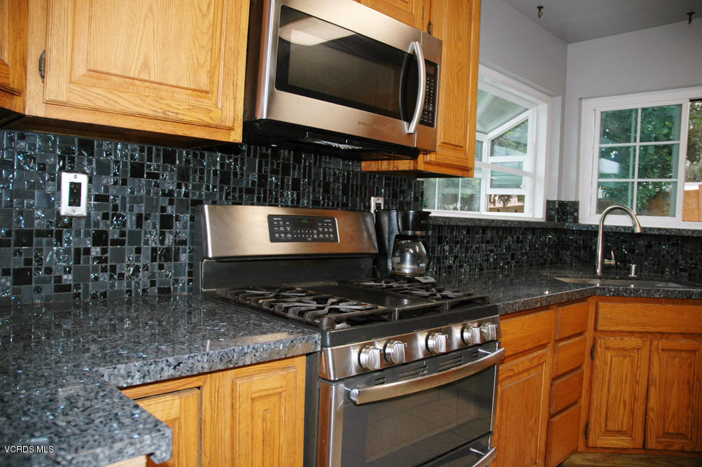 2218 Ralston Street Simi Valley, CA 93063 - Photo 3 of 23 a kitchen with granite countertop a stove and a sink