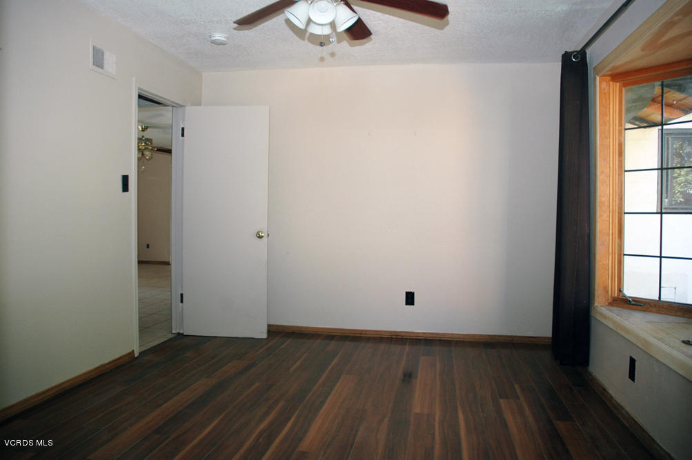 2218 Ralston Street Simi Valley, CA 93063 - Photo 6 of 23 an empty room with wooden floor and windows