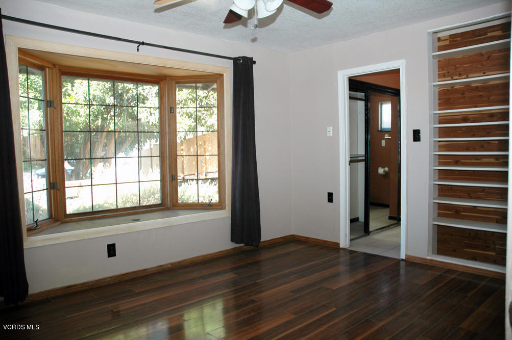 2218 Ralston Street Simi Valley, CA 93063 - Photo 8 of 23 a view of an empty room with wooden floor and a window