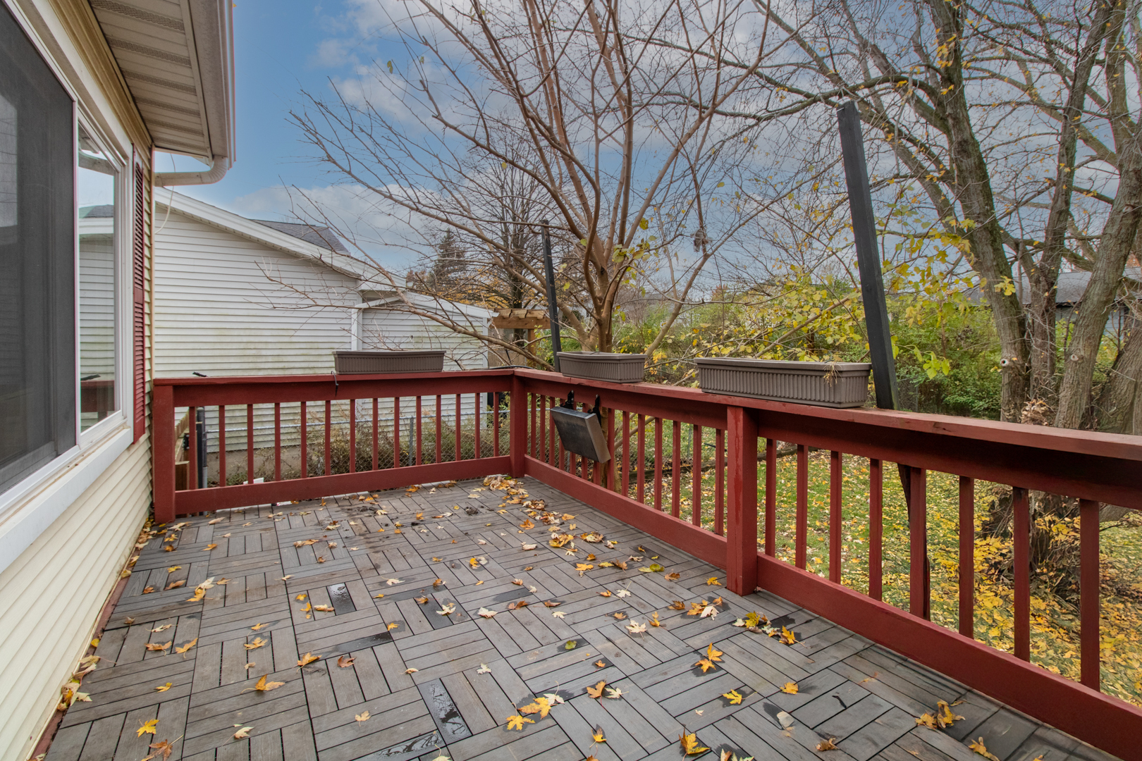 12 Timberview Drive Bloomington, IL 61701 - Photo 32 of 40 a view of a balcony with wooden floor and fence