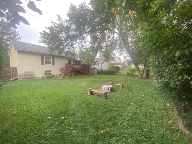 12 Timberview Drive Bloomington, IL 61701 - Photo 40 of 40 a view of a backyard with table and chairs and wooden fence