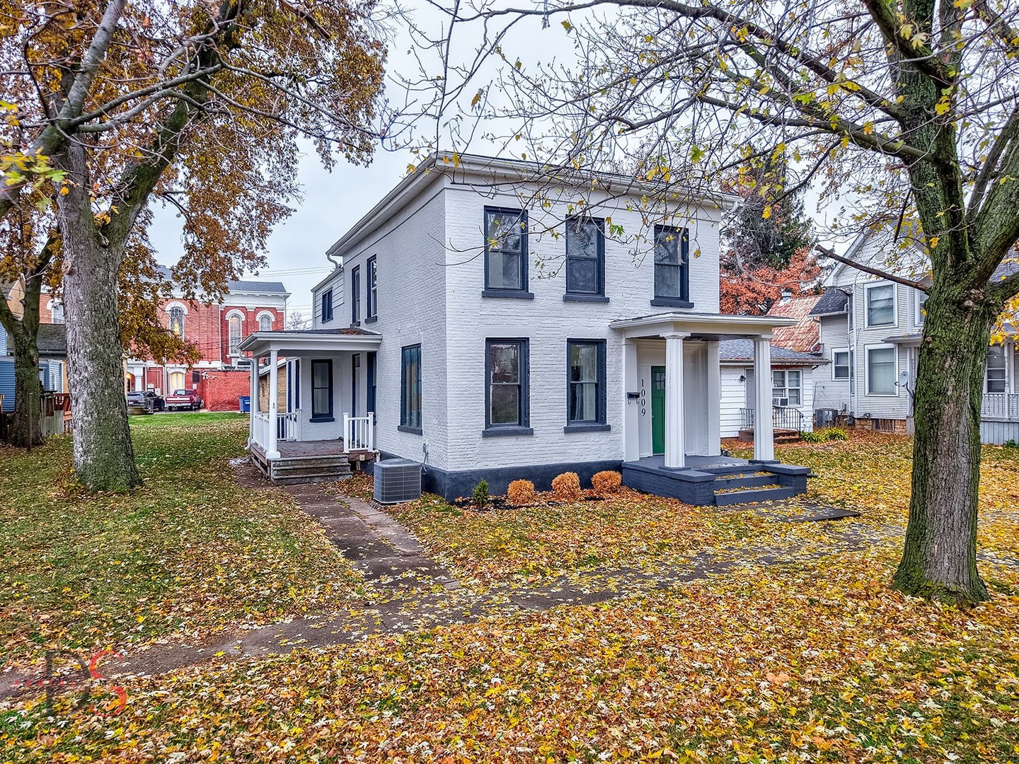 1009 Paul Street Ottawa, IL 61350 - Photo 1 of 18 a view of a white house with a large tree in front of it
