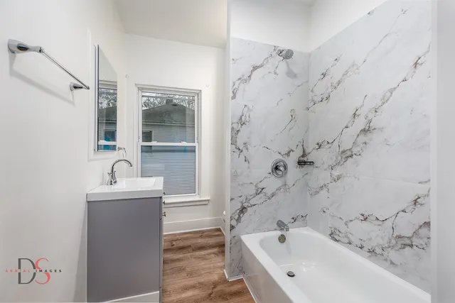 a bathroom with a bathtub and a sink