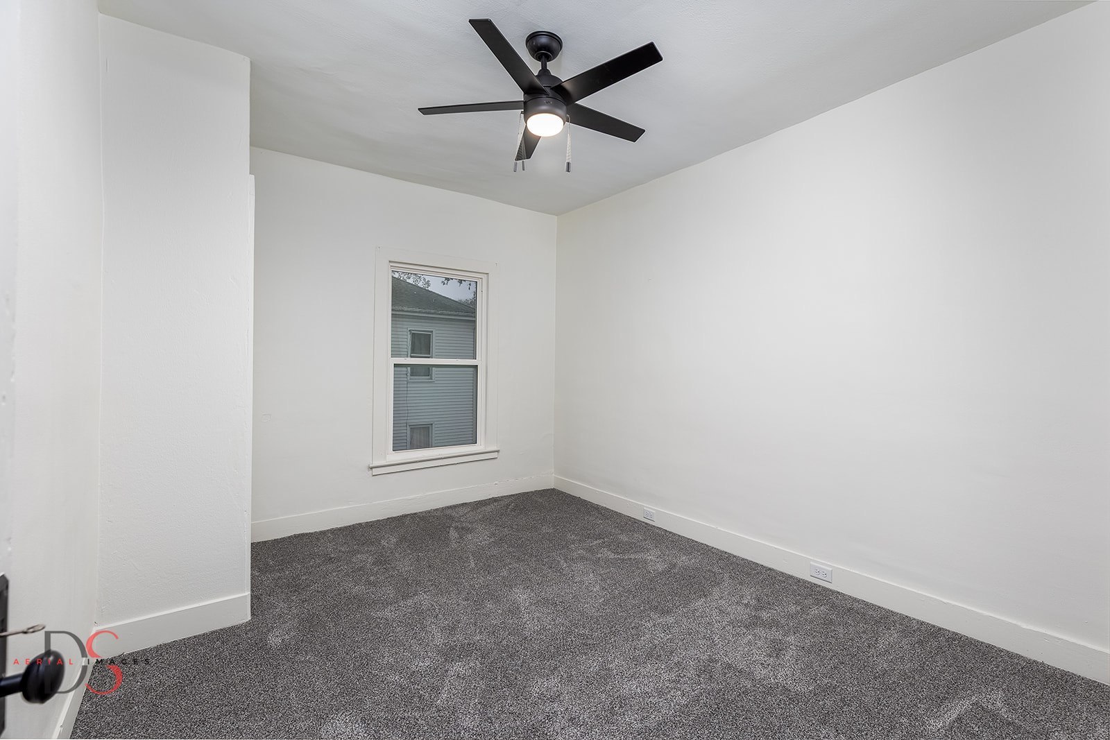 1009 Paul Street Ottawa, IL 61350 - Photo 13 of 18 an empty room with a window and a ceiling fan