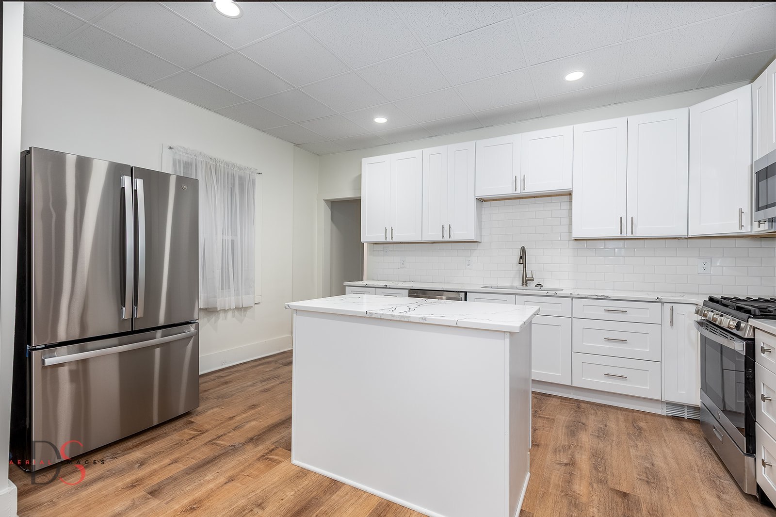 1009 Paul Street Ottawa, IL 61350 - Photo 3 of 18 a kitchen with a refrigerator sink and cabinets