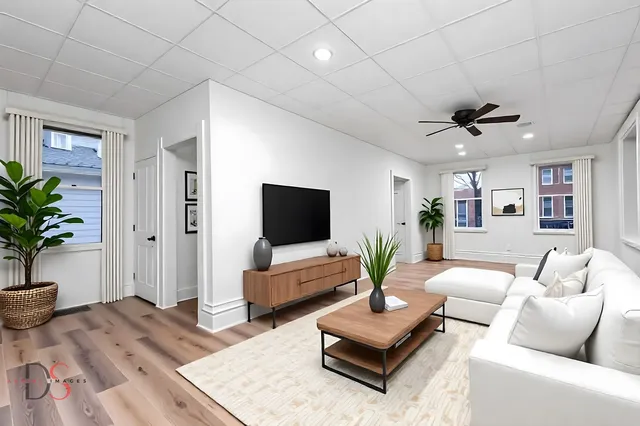 a living room with furniture and a flat screen tv