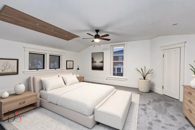 a bedroom with a large bed and a chandelier