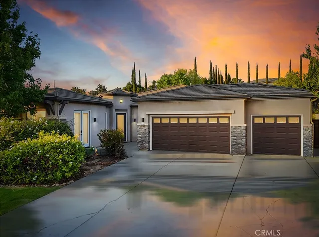 a front view of a house with a garden