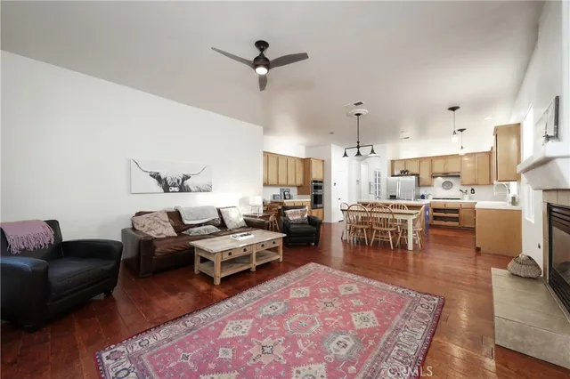 a living room with furniture a rug and kitchen view