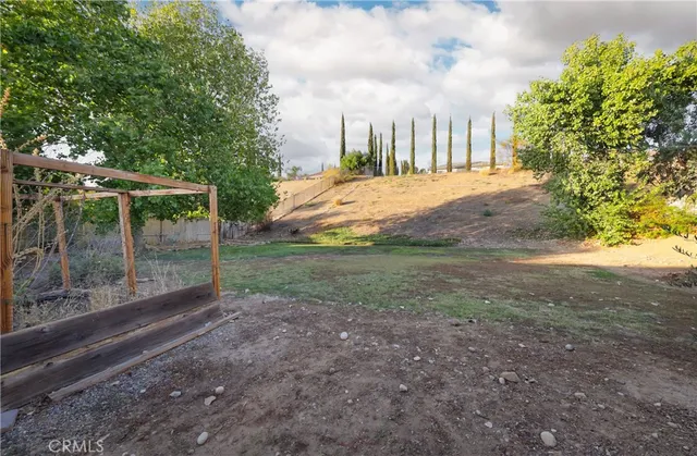 a view of a backyard with large trees
