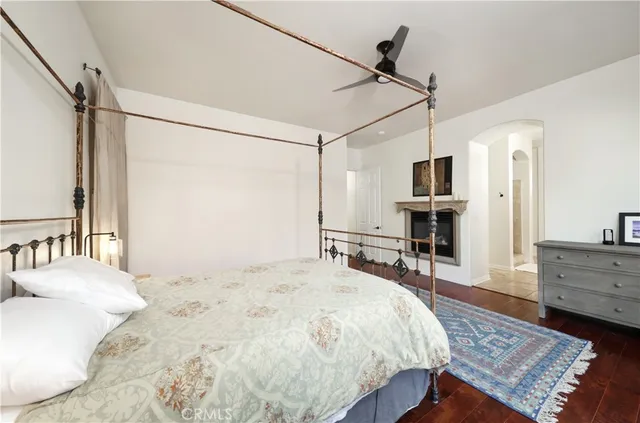 a bedroom with a bed flat screen tv and a couch