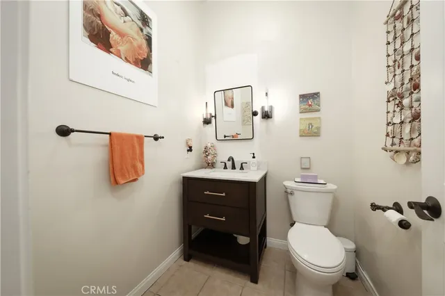 a bathroom with a toilet sink vanity and mirror