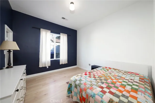 a bedroom with a bed and a lamp