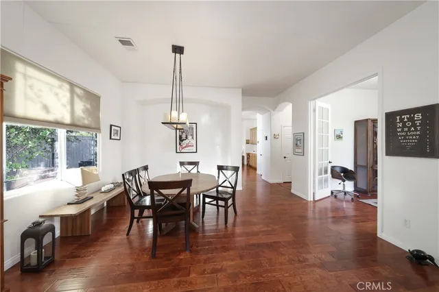 a view of a dining room with furniture window and wooden floor