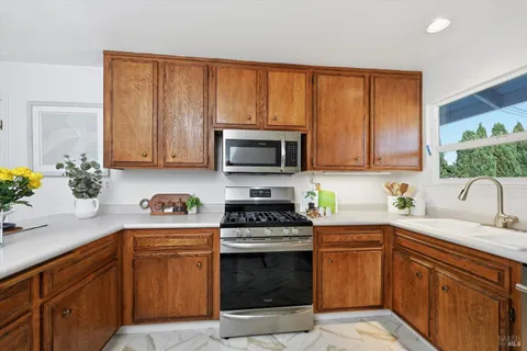 a kitchen with a sink stove and microwave