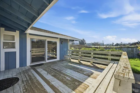 a view of a balcony with wooden floor and city view