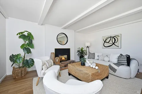 a living room with furniture a clock and a fireplace