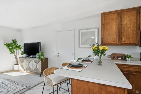a dining room with furniture and wooden floor
