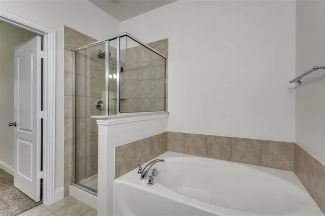 a bathroom with a bathtub and shower
