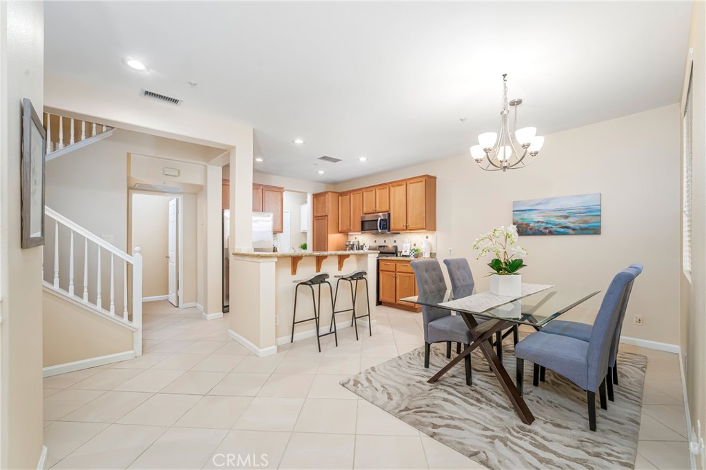 97 Chadron Circle Ladera Ranch, CA 92694 - Photo 8 of 56 Large dining room open to the island kitchen with breakfast bar and to the living room as well with Southwest facing windows with open views