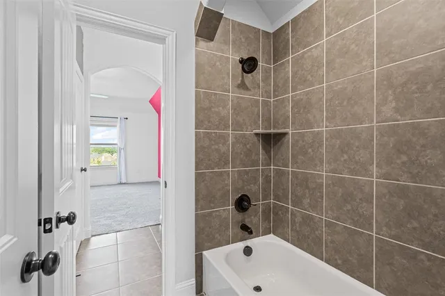 a bathroom with a bathtub and shower