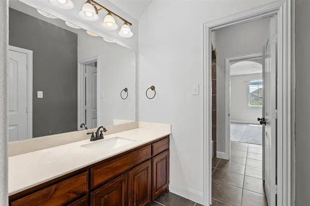 a bathroom with a sink vanity and a mirror