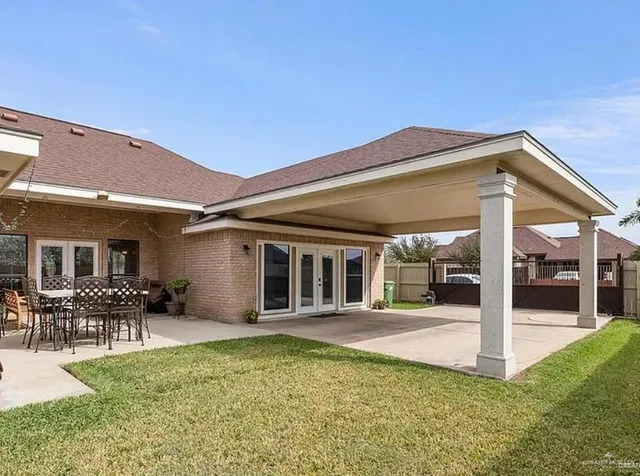 a view of a house with backyard porch and sitting area