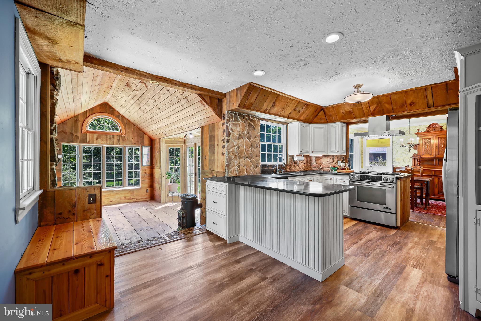 339 Mountain View Road Skillman, NJ 08558 - Photo 16 of 54 a kitchen with granite countertop a stove and wooden floors