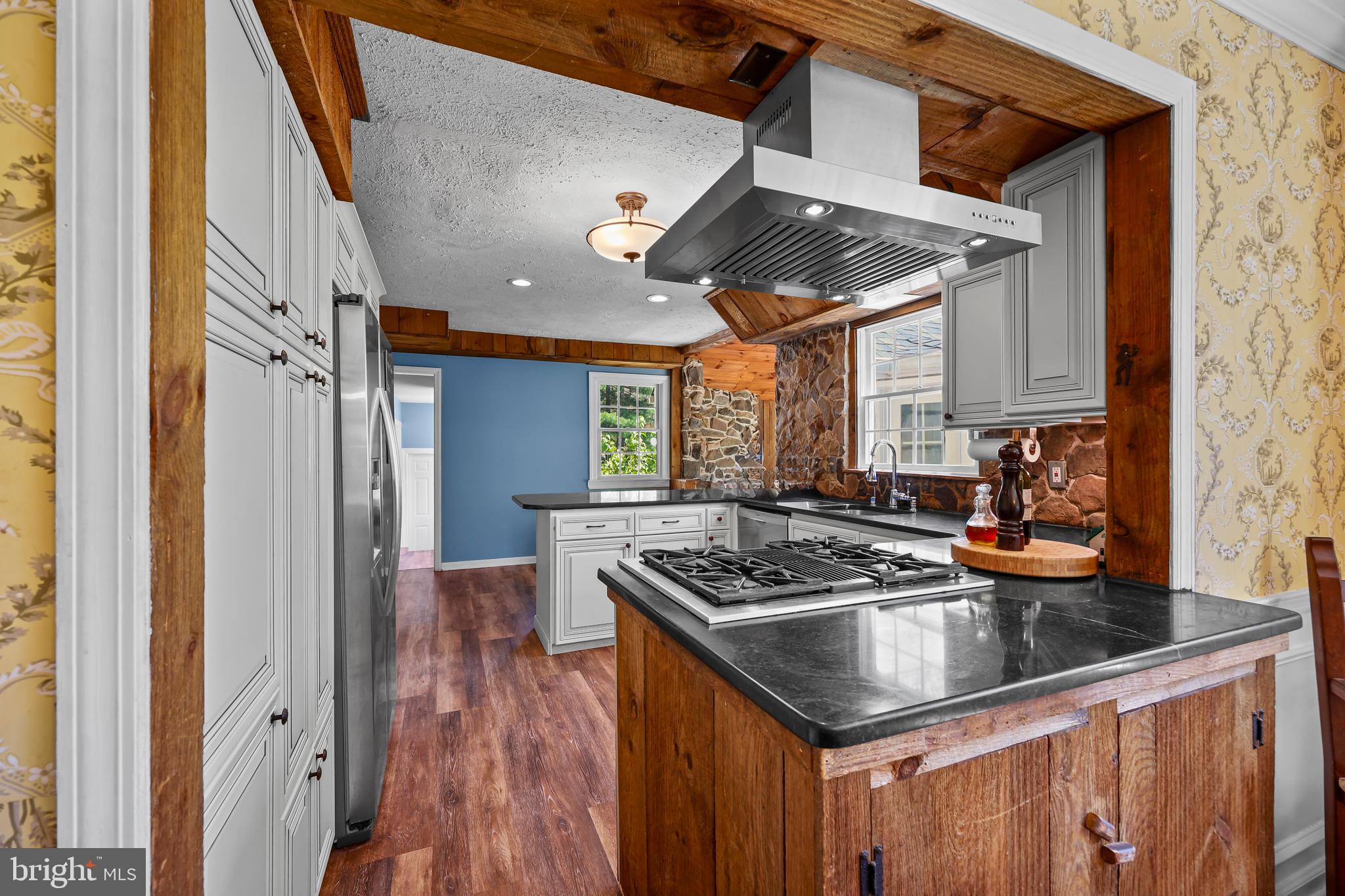 339 Mountain View Road Skillman, NJ 08558 - Photo 18 of 54 a kitchen with stainless steel appliances granite countertop a sink a stove and a wooden floor
