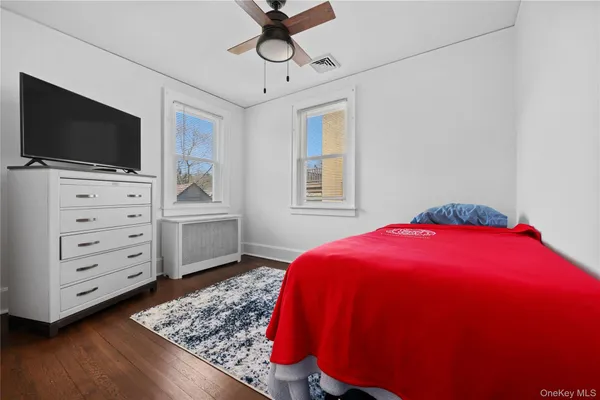 a bedroom with a bed and flat screen tv