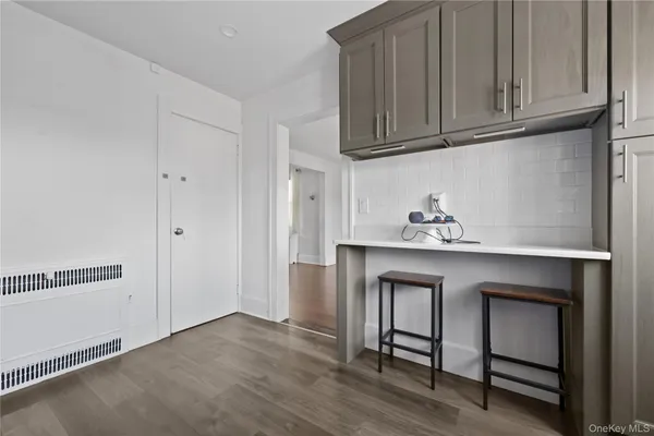 a hallway with cabinets and wooden floor