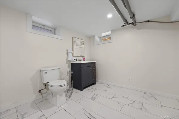 a bathroom with a sink a toilet and vanity