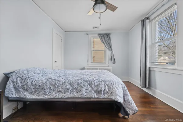 a bedroom with a bed window and wall painting
