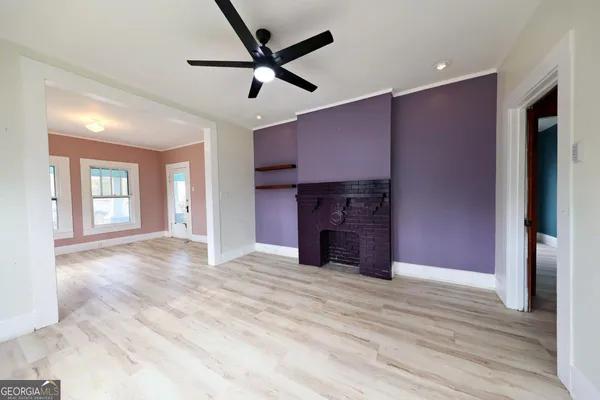 a view of a livingroom with a fireplace and a ceiling fan