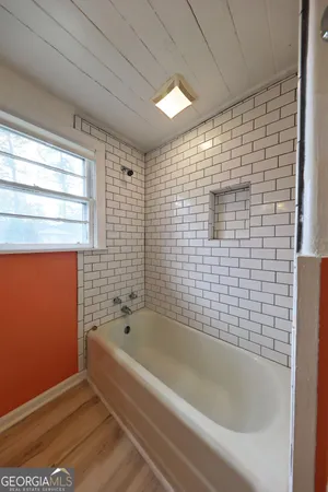a bathroom with a bathtub and shower