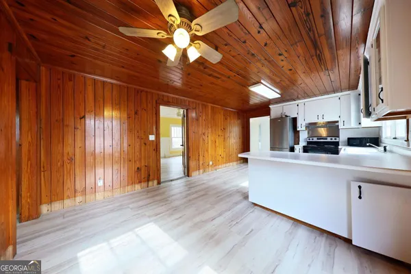 a living room with stainless steel appliances granite countertop furniture and a kitchen view
