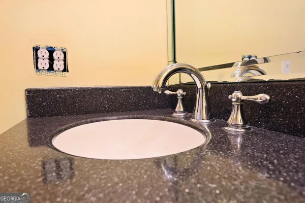 a bathroom with a sink and mirror
