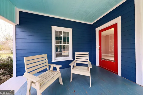a view of a two chairs in the patio