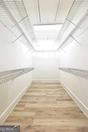 a view of a room with wooden floor