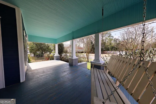 a view of balcony with wooden floor